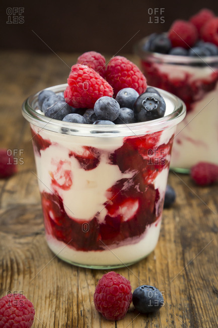 Glasses of Greek yogurt with berry groats- fresh blueberries and raspberries