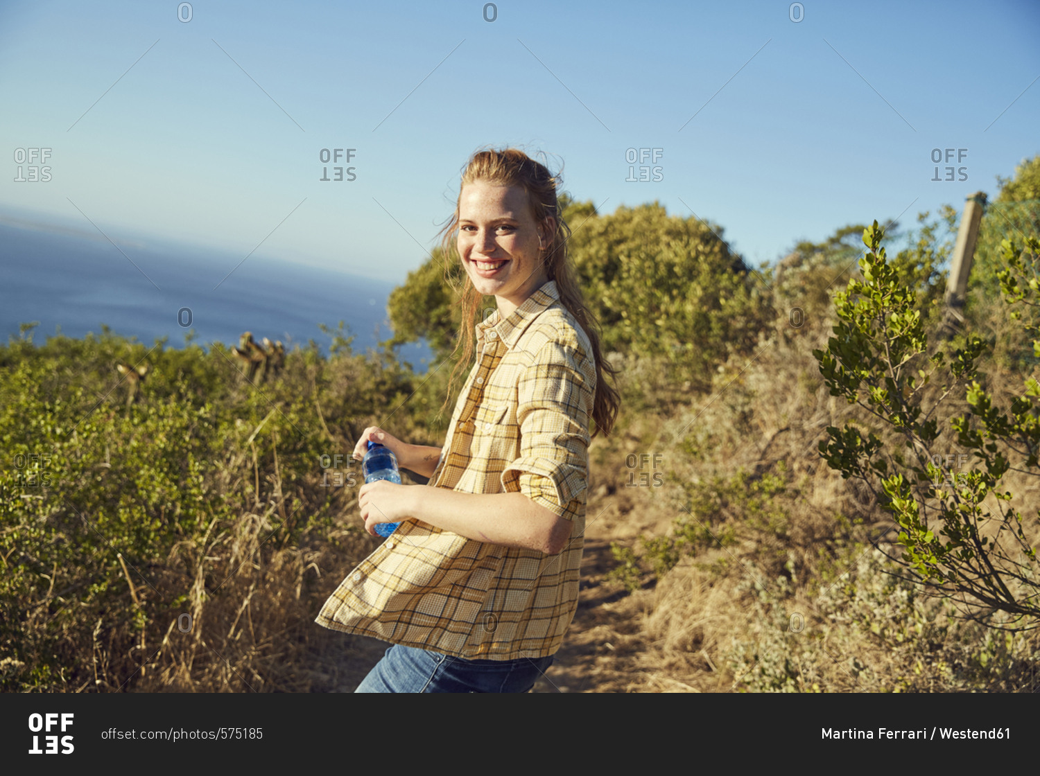 South Africa- Cape Town- Signal Hill- smiling young woman hiking at the coast