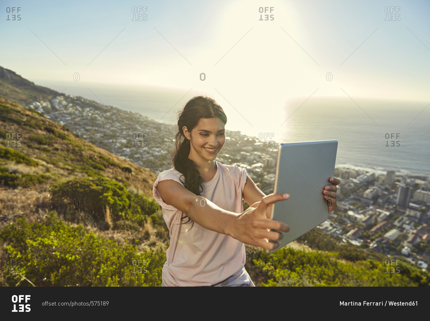South Africa- Cape Town- Signal Hill- young woman above the city taking a selfie with tablet