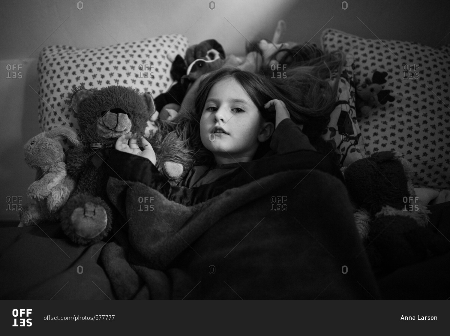 young-girl-lying-in-bed-in-black-and-white-stock-photo-offset