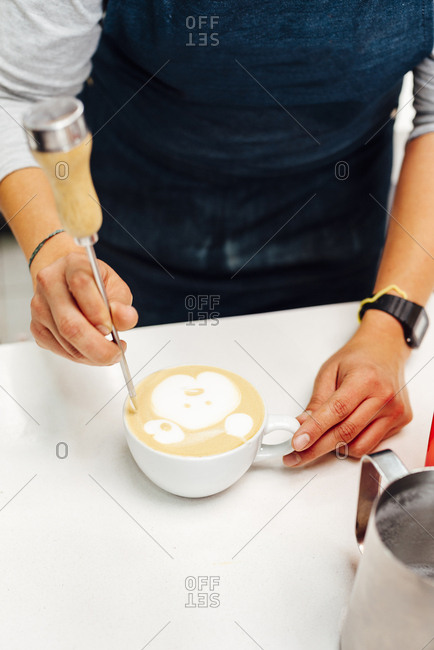Woman preparing a cup of coffee for a client in Bogota, Colombia