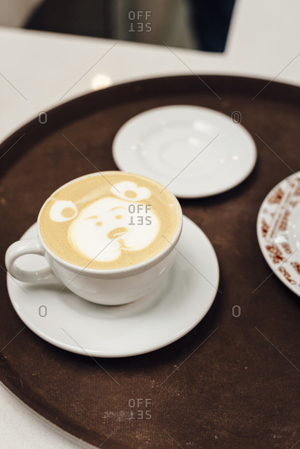 A latte with a bear pattern on a tray in Bogota, Colombia