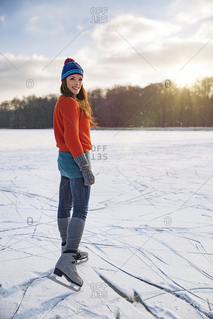 Portrait of woman ice skating on frozen lake