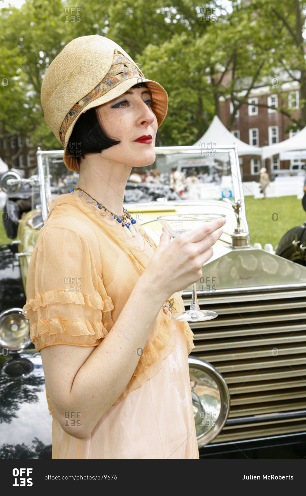 New York City, United States - June 10, 2017: 1920\'s Jazz\
Age Lawn Party at Governors Island, Woman dressed as a flapper\
drinking a martini at a garden party stock photo - OFFSET