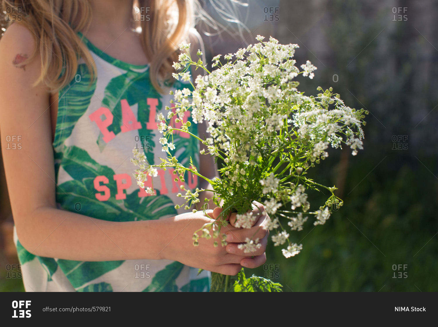 Close-up of girl holding yarrow flower bouquet