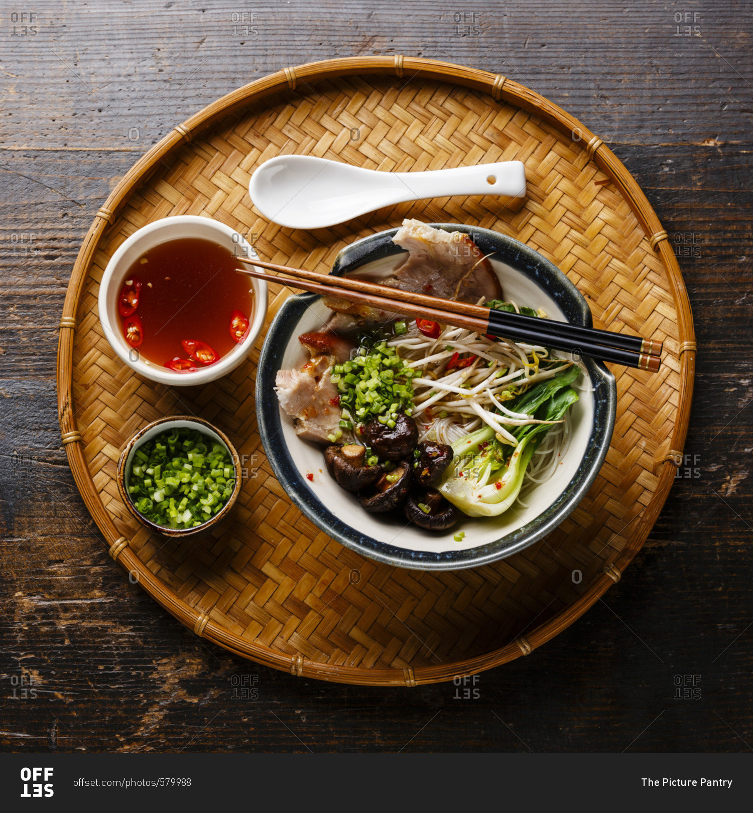 Rice noodles with boiled pork, wheat germ and shiitake mushrooms on wooden background