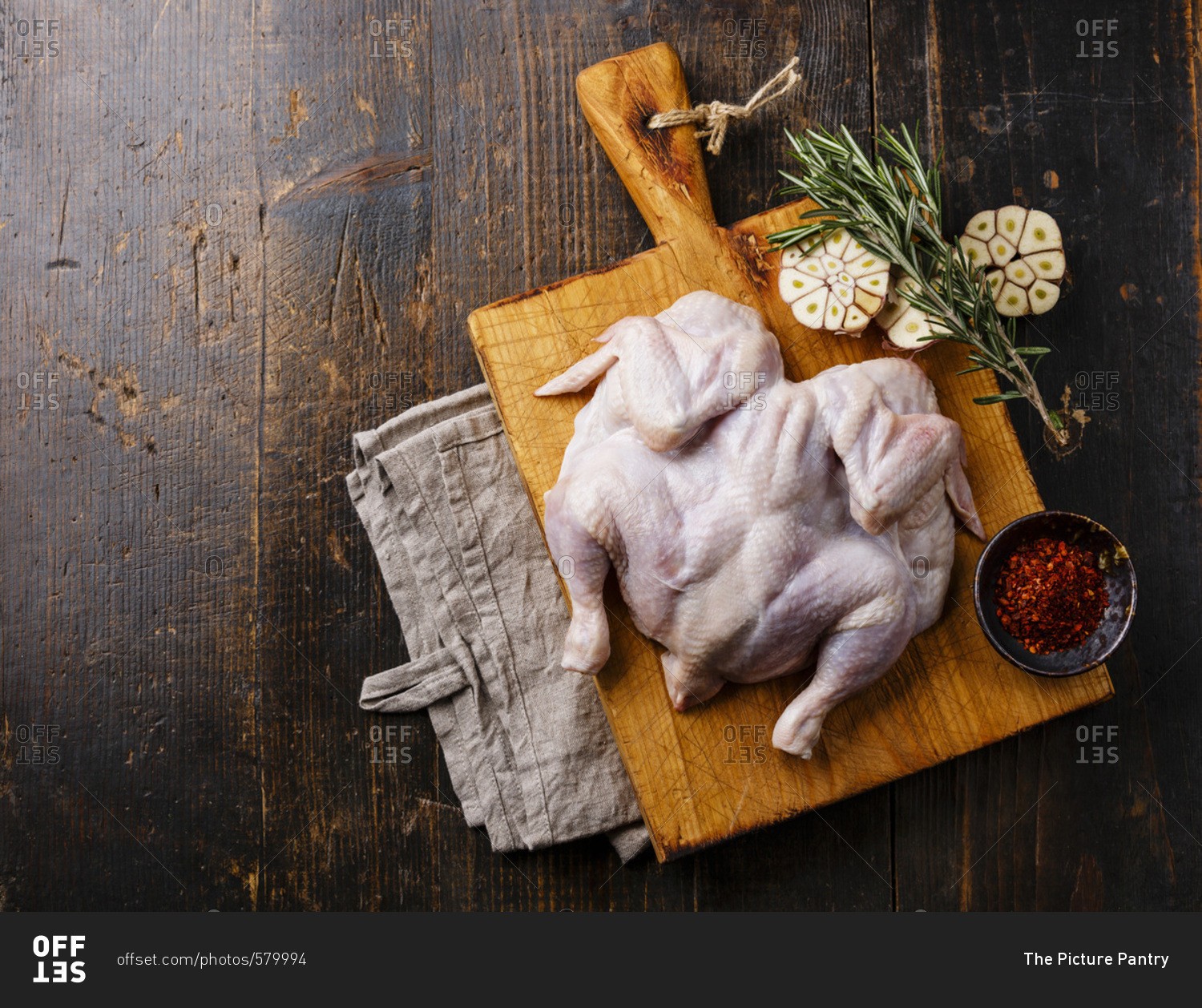 Raw whole chicken on wooden background
