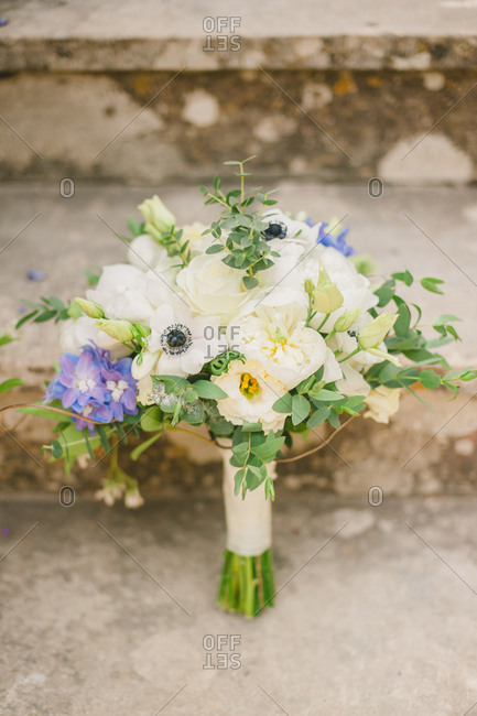 Flower bouquet propped against stone steps
