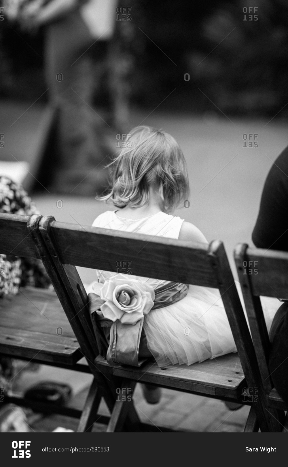 Flower girl in chair at wedding