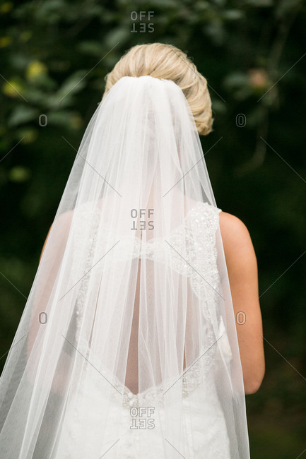 Head of bride in long veil outside