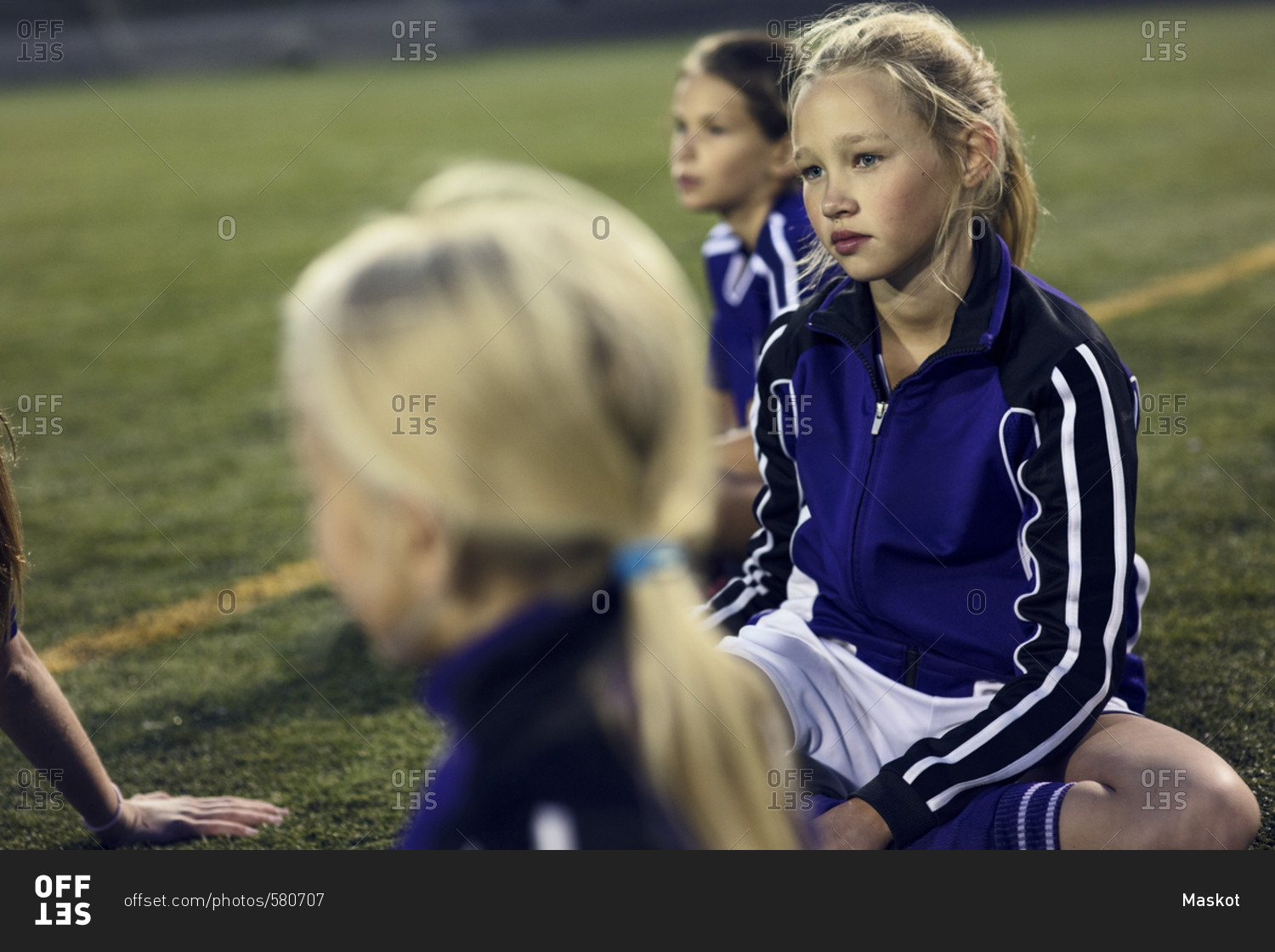 High angle view of girls relaxing on soccer field