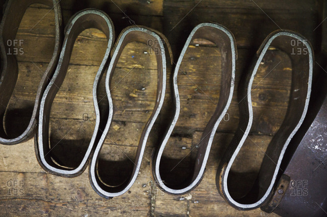 Metal shoe forms, template shapes for cutting leather components, in a shoemaker's workshop
