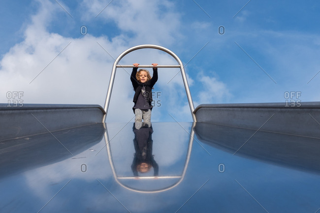 Girl waiting at the top of a giant slide