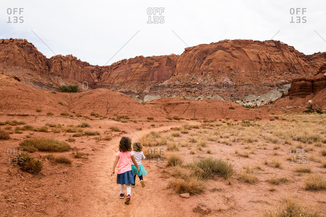 Two children running along the trail at Capitol Reef NP, Utah