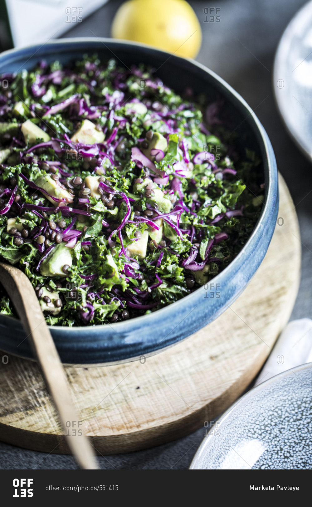Bowl of chopped salad with purple cabbage, avocado, kale and lentils