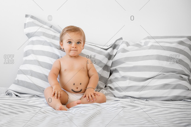 Toddler with smiley face on tummy