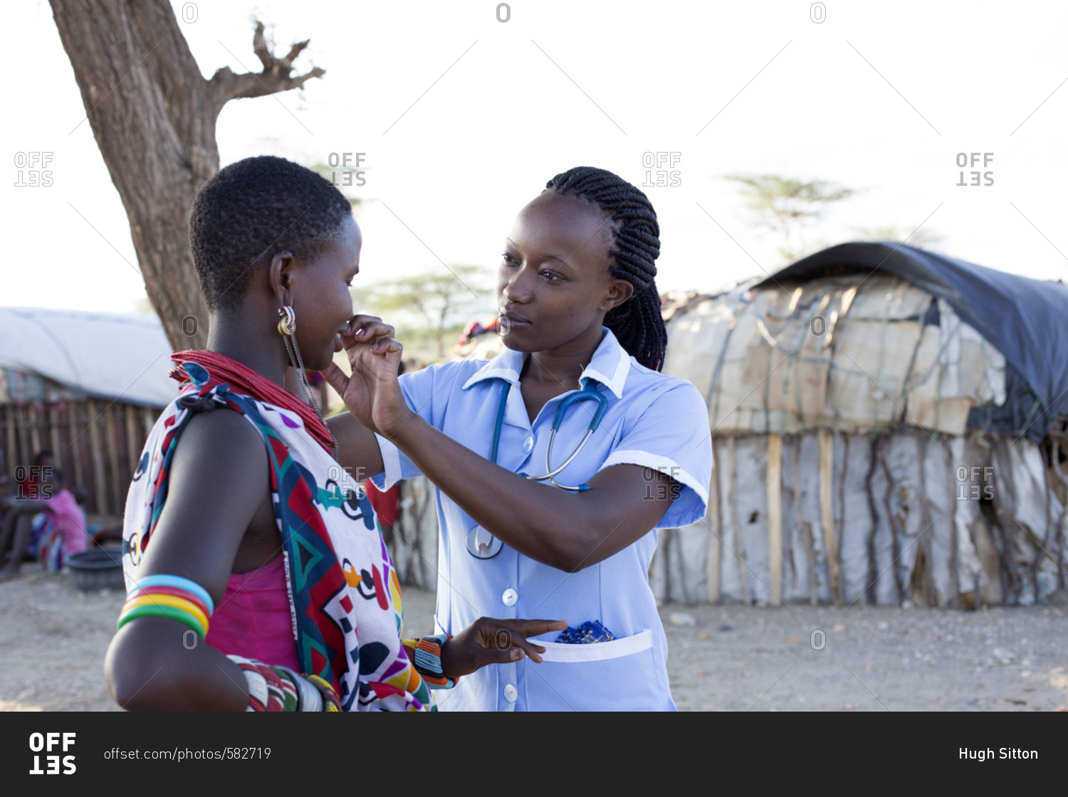 Kenya, Africa April 25, 2017 Nurse examining patient in rural