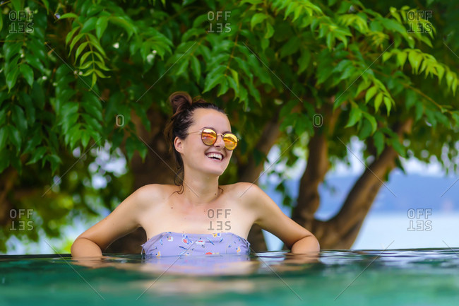 Young woman bathing in infinity pool