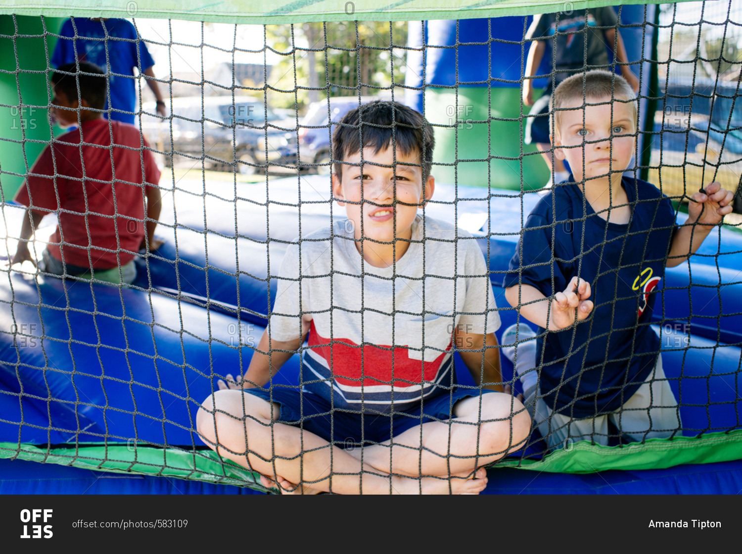 Kids looking through bounce house net