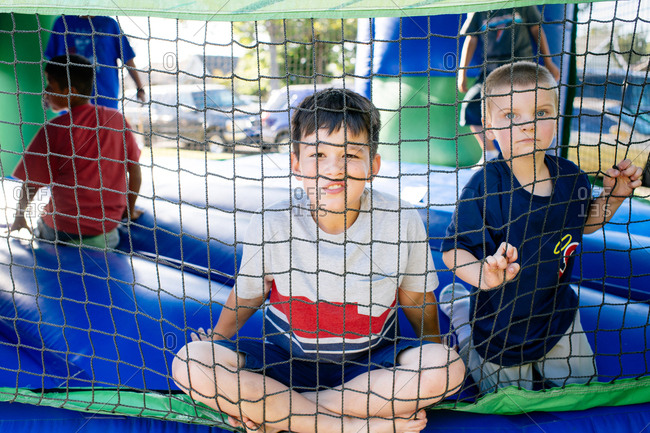 Kids looking through bounce house net