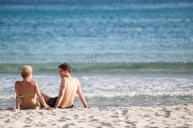 Young couples naked on the beach