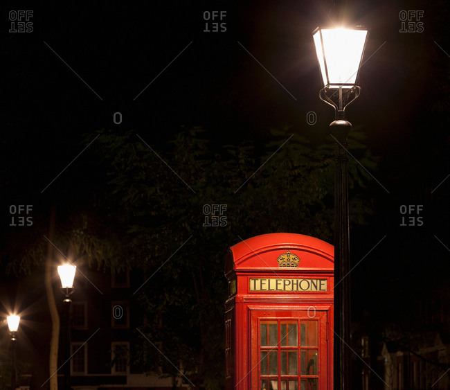 Red telephone box on city street