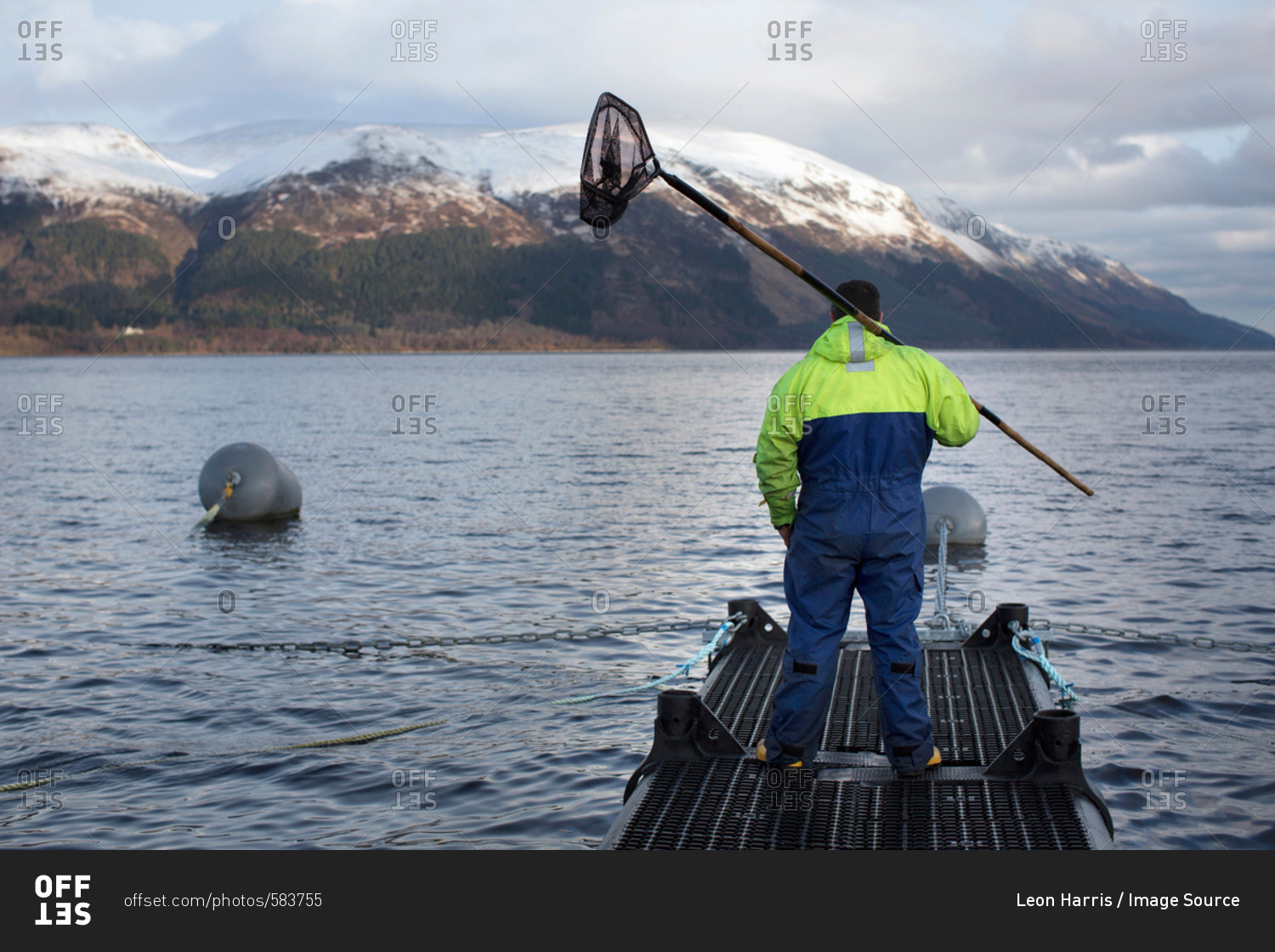 Worker at salmon farm in rural lake