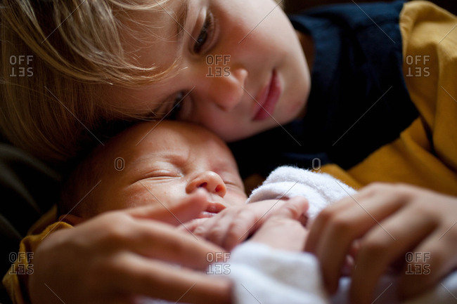 Young boy holding baby brother
