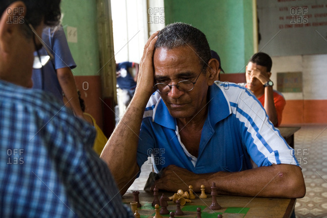 Havana, Republic of Cuba - August 6, 2008. A thinking chess player in the middle of a game of chess