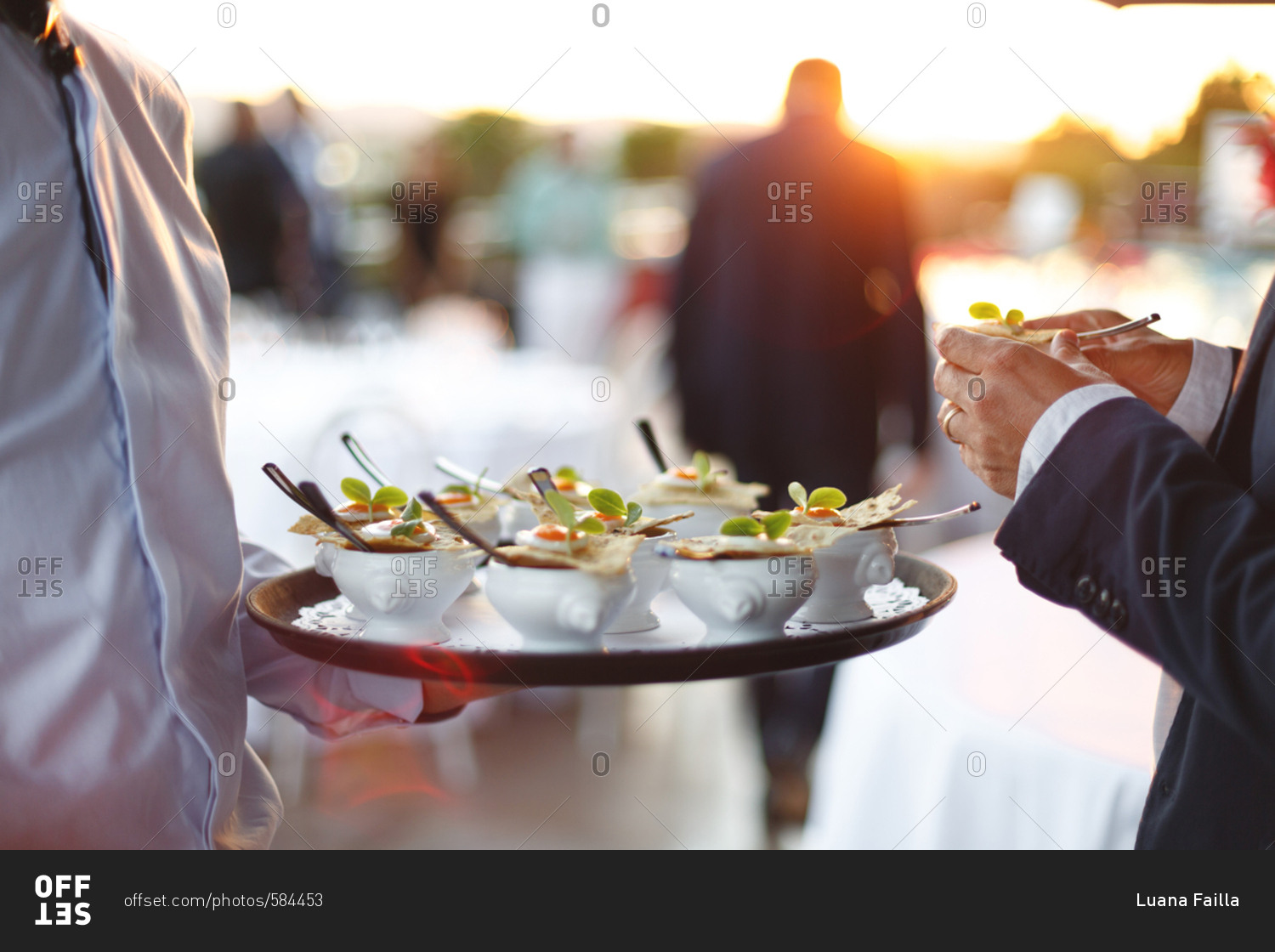 Waiter holding a serving tray with hors d\'oeuvres in small dishes