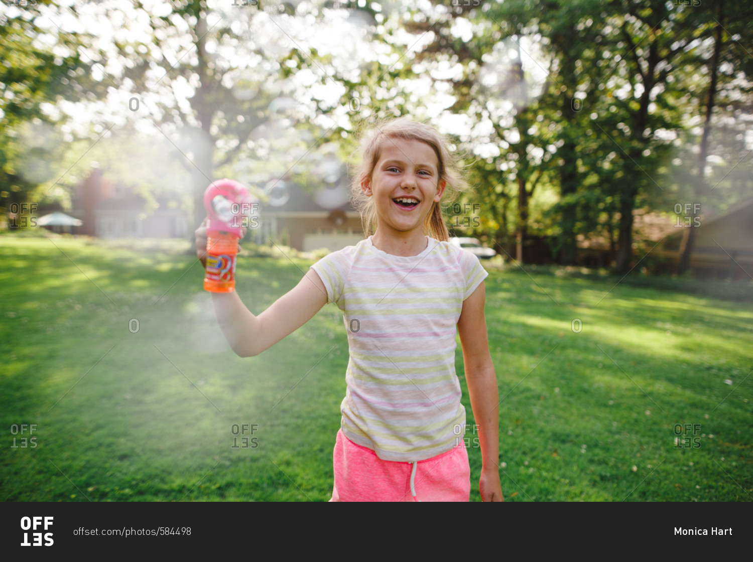 Little girl with a bubble gun