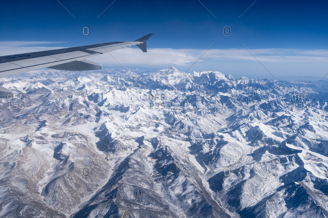 A jet in flight above the mountains of the high Tibet plateau