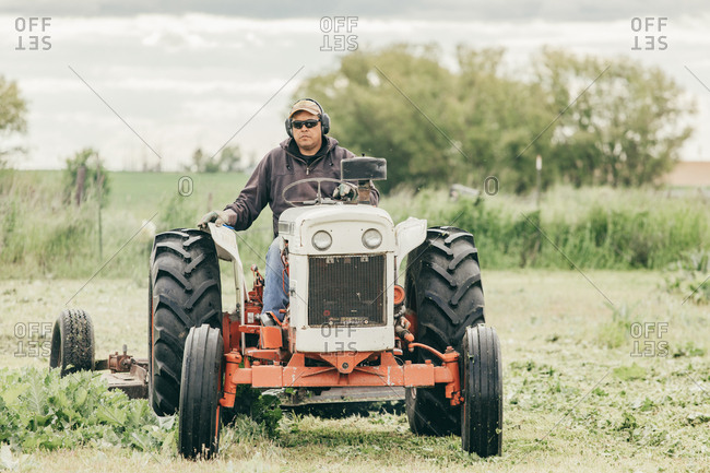 Umatilla Reservation, Pendleton, Oregon - May 17, 2017: Man mowing lawn with a tractor on the Umatilla Reservation in Oregon