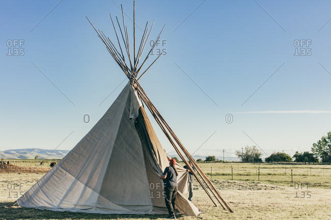 Umatilla Reservation, Pendleton, Oregon - May 18, 2017: Couple setting up a tipi