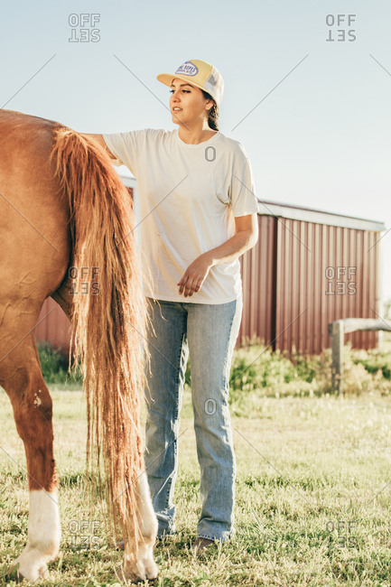 Umatilla Reservation, Pendleton, Oregon - May 18, 2017: Girl petting horse on the Umatilla Reservation in Oregon