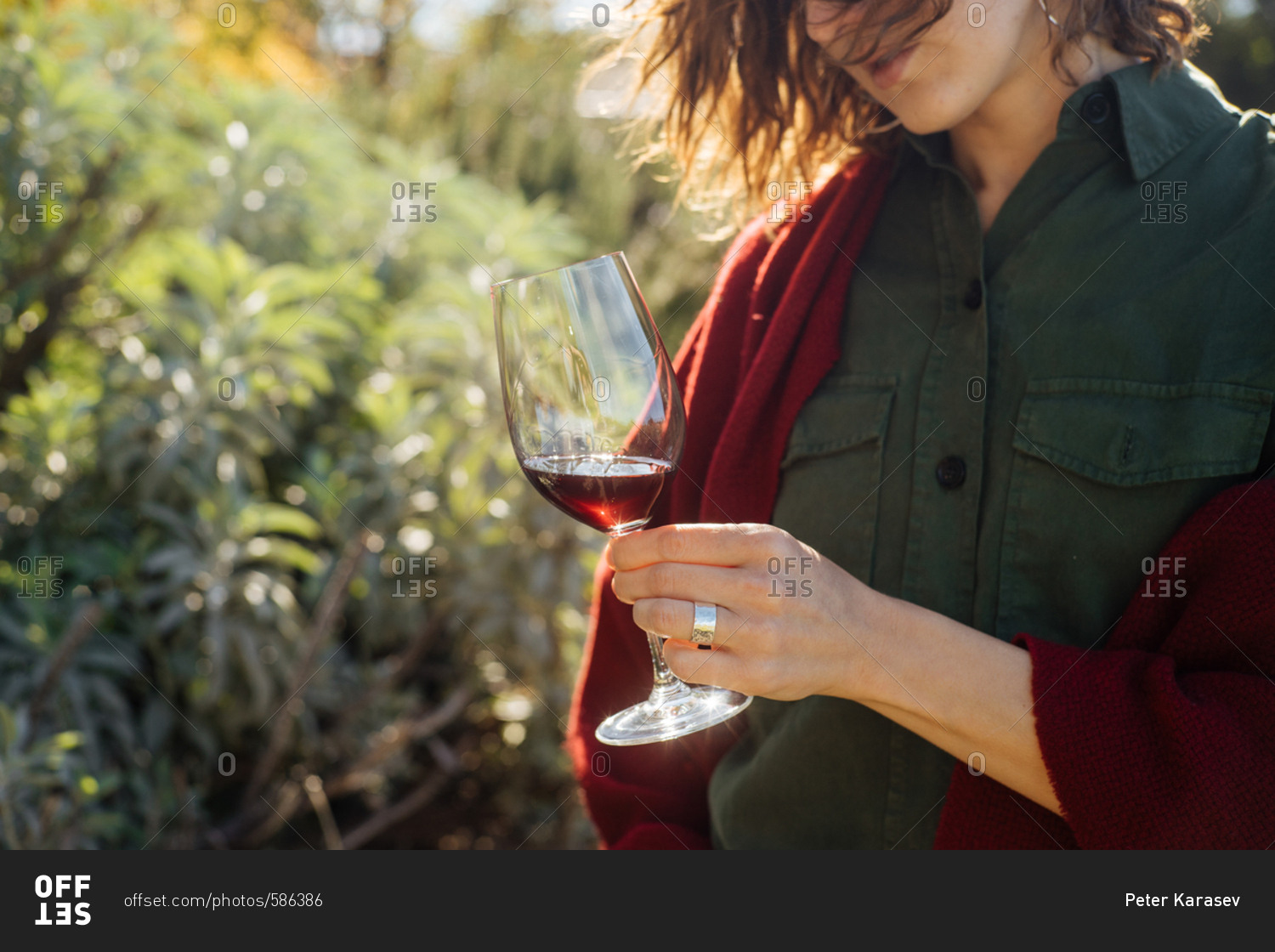 Woman standing outside swirling a glass of red wine
