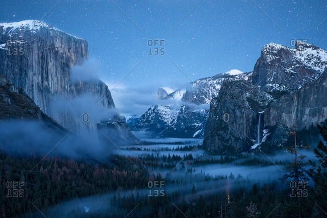 Yosemite Valley at night with clouds