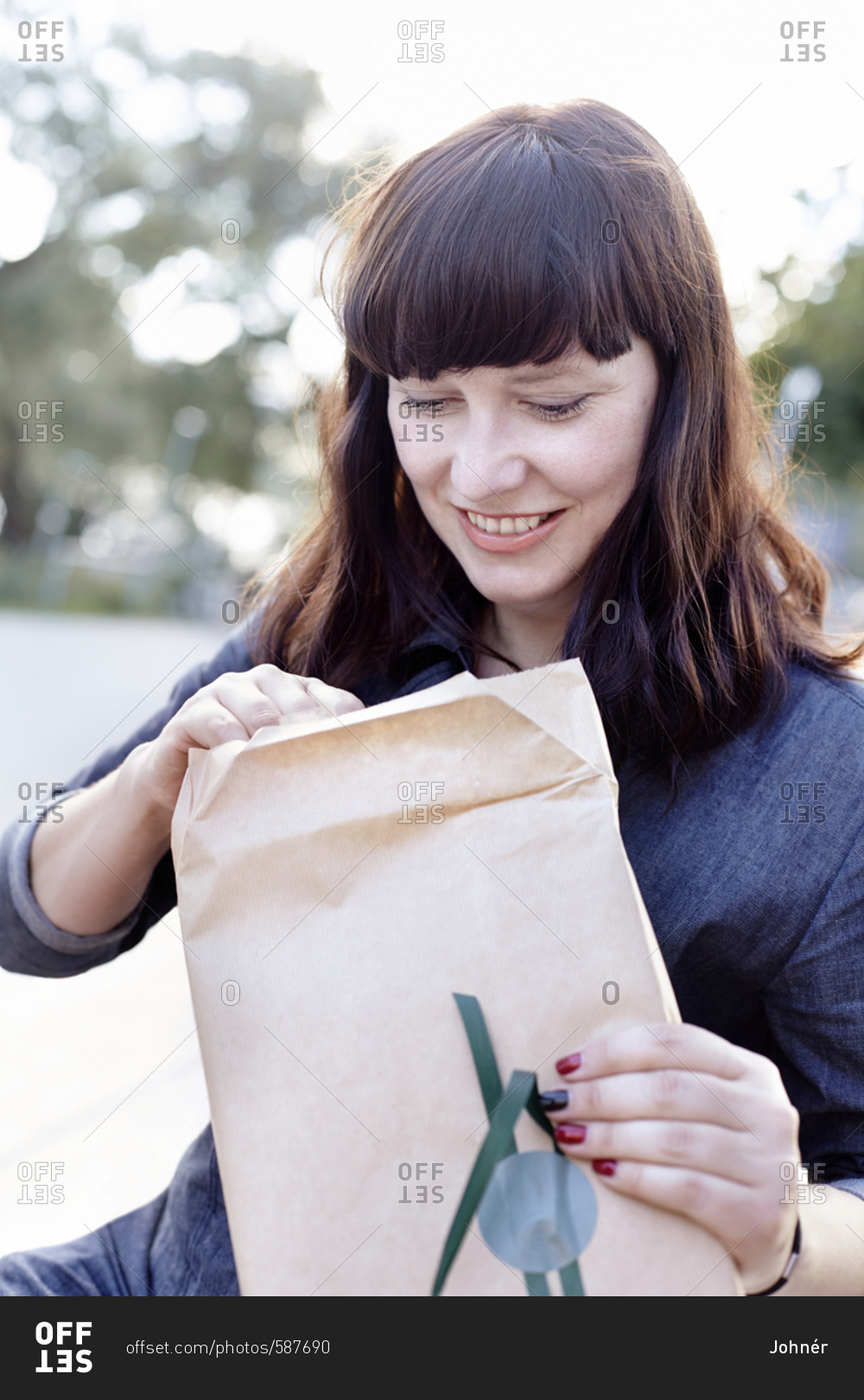 Young woman opening envelope