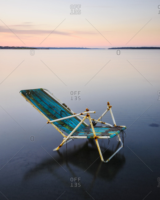 Broken sun chair at sea