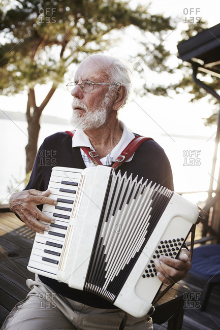 Senior man playing accordion - Offset