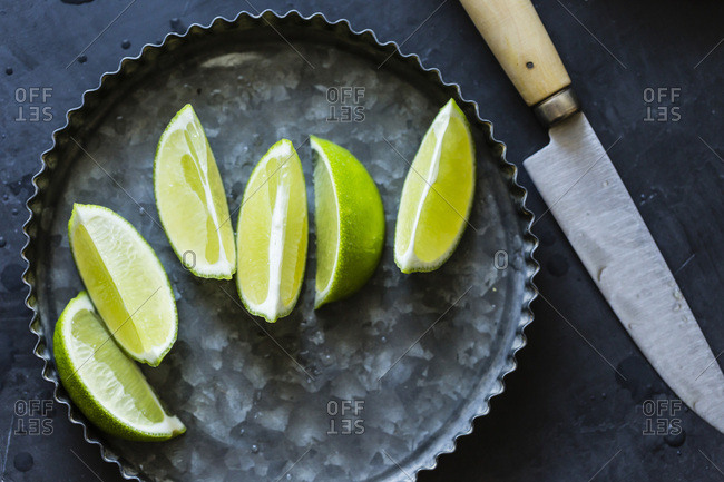 Lime wedges on a dark background