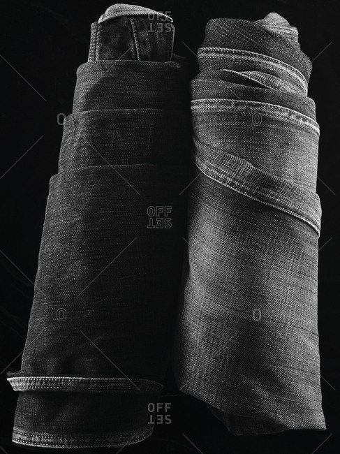 Close-up of two pairs of folded denim jeans