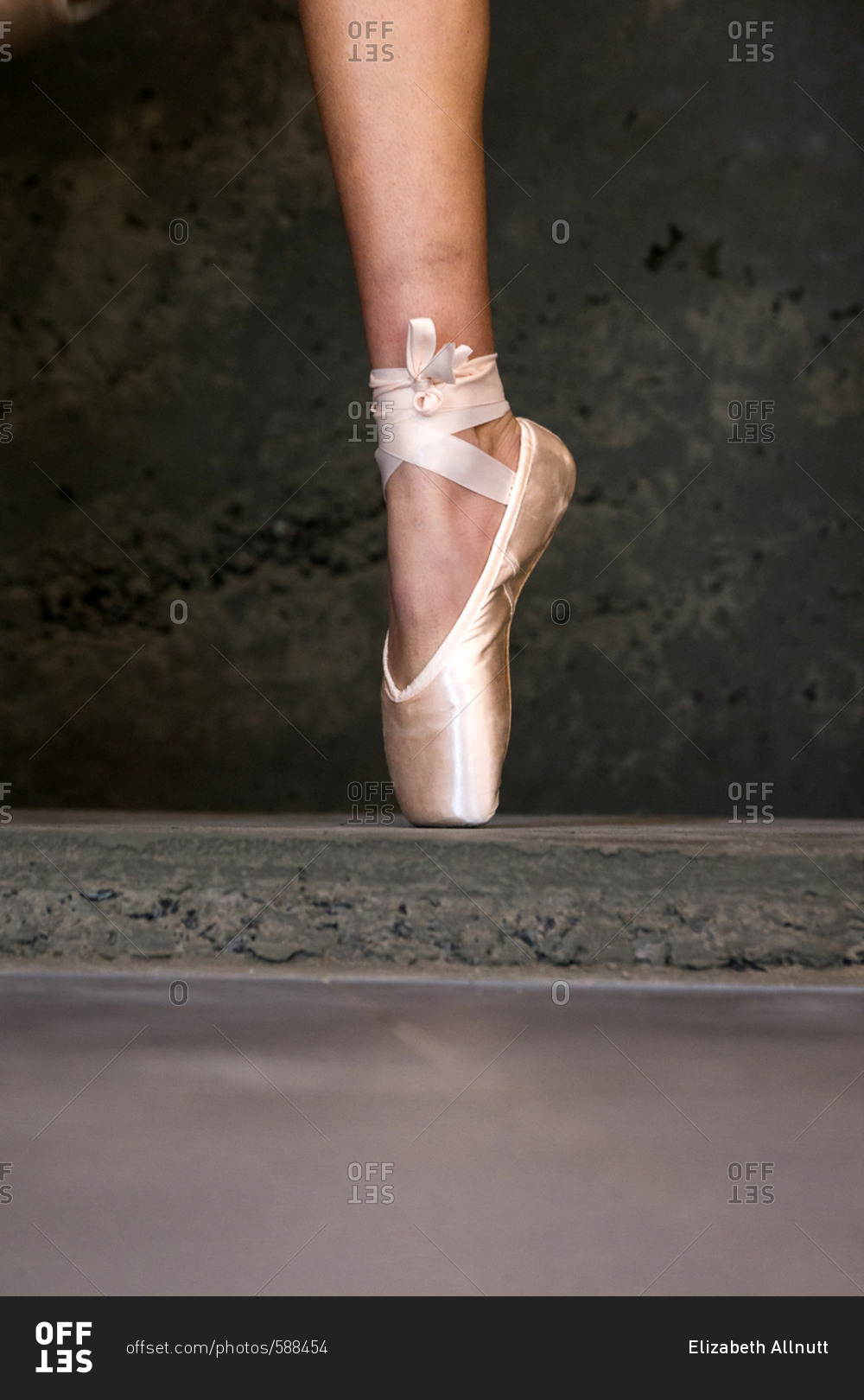 Single foot of a ballet dancer in pointe shoe