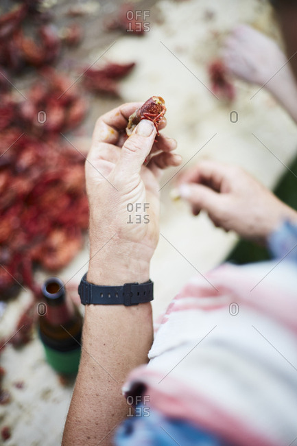Hand holding a crawfish at boil