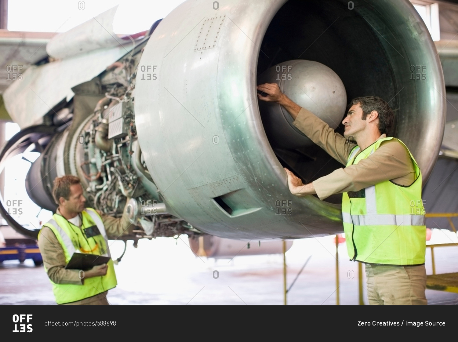 Aircraft workers checking airplane