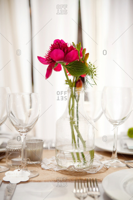 Pink flowers in a jar on an elegant reception table