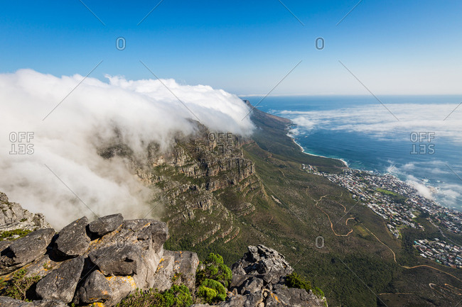 Table Mountain covered in a tablecloth of orographic clouds, Camps Bay below covered in low cloud, Cape Town, South Africa, Africa