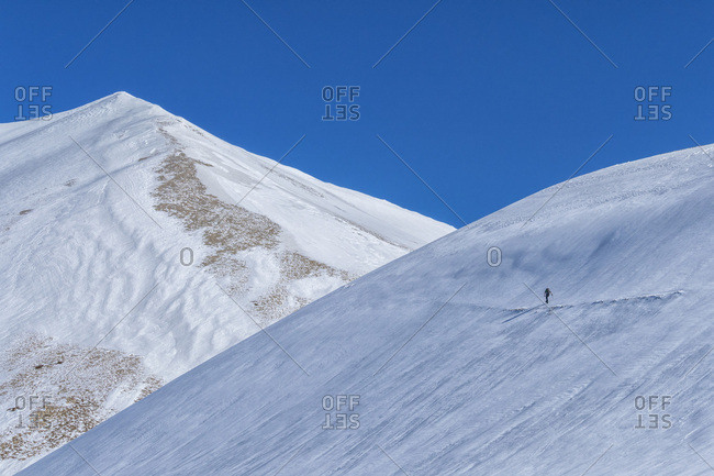 Hiker on mountain Vettore in winter, Sibillini National Park, Umbria, Italy, Europe