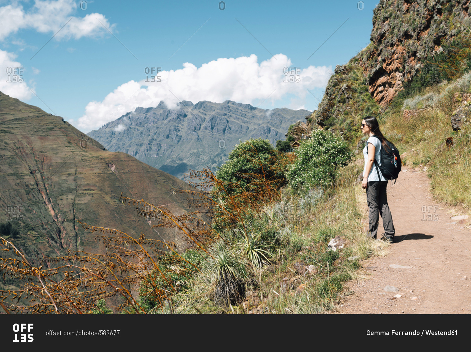 Peru- Valle Sagrado- woman hiking on the way to the Incan ruins of Pisac Archaeological Complex