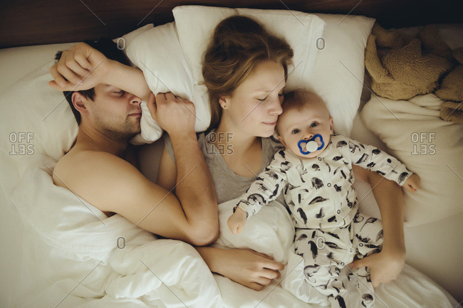 mom and dad sleeping with baby
